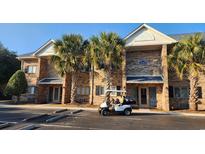 Brick building exterior with golf cart and parking at 210 Double Eagle Dr. # H-1, Surfside Beach, SC 29575