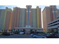 Exterior view of Bay Watch Resort buildings, showcasing its size, balconies, and parking area at 2701 S. Ocean B S Ocean Blvd. # 508, North Myrtle Beach, SC 29582