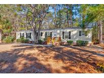 Single-wide manufactured home with wood siding and a spacious yard at 3790 Woodridge Circle, Little River, SC 29566