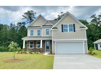 Charming two-story home featuring stone accents, a two-car garage, and a well-manicured lawn at 400 Clear Lake Dr., Conway, SC 29526