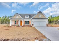 Charming single-story home featuring orange shutters, a two-car garage, and a well-manicured lawn at 4745 Huckleberry Ln., Conway, SC 29526