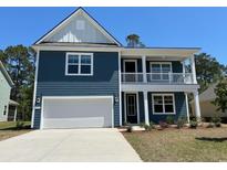 Charming two-story home with a two-car garage, blue siding, and a quaint second story porch at 593 Haven View Way, Murrells Inlet, SC 29576