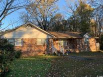 Exterior of brick home featuring a front-facing gable and mature landscaping at 5944 Rose Hill Rd., Georgetown, SC 29440