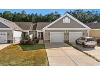 Attractive exterior of a two-story home with a two-car garage and well-manicured lawn at 779 Salerno Circle # 1204 - D, Myrtle Beach, SC 29579