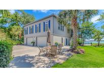Beautiful two-story home with blue shutters and a large patio area, perfect for outdoor entertaining at 88 Gillette Pl., Murrells Inlet, SC 29576