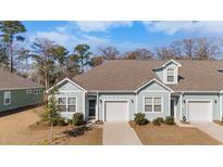 Craftsman style home with light blue siding, white trim, and a two-car garage at 94 Vineyard Place # 11, Pawleys Island, SC 29585