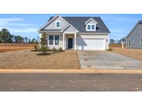 Charming two-story home with neutral siding, gabled roof, and a two car garage in a well manicured community at 132 Joyce Dr, Longs, SC 29568