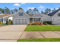 Gray house with a three-car garage and landscaped lawn at 1775 Suncrest Dr., Myrtle Beach, SC 29577