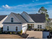 Charming single-Gathering home with a well-manicured lawn, attached garage, and neutral color scheme at 1829 Wood Stork Dr., Conway, SC 29526