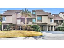 Attractive condo building with a spacious driveway and lush landscaping at 203 Heron Marsh Dr. # 78, Pawleys Island, SC 29585