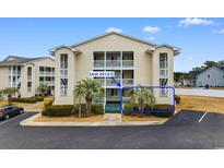 Nice condo building with palm trees and parking at 212-C Landing Rd. # 212-C, North Myrtle Beach, SC 29582
