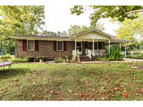 Brick ranch house with covered porch, landscaping, and large yard at 3657 Highway 472, Conway, SC 29526