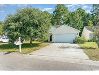 House exterior featuring a two-car garage and a well-manicured lawn at 396 Bellegrove Dr., Myrtle Beach, SC 29579