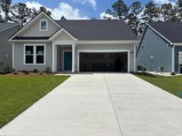 Charming single-Gathering home with an attached two-car garage and beautifully manicured lawn at 456 Sun Colony Blvd., Longs, SC 29568