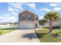 Two-story house with gray siding, a white garage door, and a landscaped lawn at 536 Affinity Dr., Myrtle Beach, SC 29588