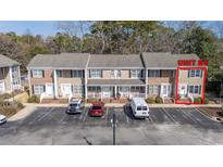 A charming townhouse showcases neat landscaping and designated parking spaces for convenient access at 6702 Jefferson Pl. # B6, Myrtle Beach, SC 29572