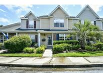 Two-story townhome with manicured landscaping and inviting entryway at 764 Wilshire Ln. # 764, Murrells Inlet, SC 29576
