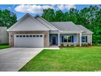 Charming single-story home with brick accents, a manicured lawn, and an attached two-car garage at 106 Riverwatch Dr., Conway, SC 29527