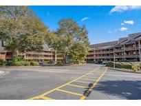 Exterior view of a two-story building with parking lot at 108 Rothbury Circle # 207, Myrtle Beach, SC 29572