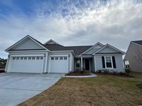 Charming single-story home boasts a three-car garage, and welcoming curb appeal at 1121 Oxeye St., North Myrtle Beach, SC 29582