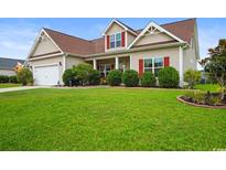 Charming two-story home with red shutters and a well-manicured green lawn at 1425 Tiger Grand Dr., Conway, SC 29526