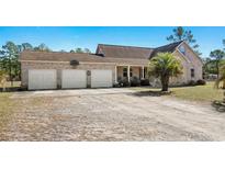 Charming brick home featuring an attached three-car garage and a well-manicured front yard at 2531 Smiley Ln., Conway, SC 29526