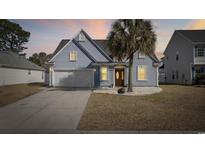 Charming two-story home with a well-manicured lawn and attached two-car garage at 455 Blackberry Ln., Myrtle Beach, SC 29579