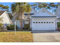 Brick ranch house with attached garage and palm tree at 516 5Th Ave. S, North Myrtle Beach, SC 29582