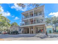 Stunning three-story beach house boasts multiple balconies and covered parking at 6001-D5 S Kings Hwy., Myrtle Beach, SC 29575