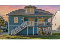 Inviting two-story beach home with elevated deck and classic coastal charm at 719 N Waccamaw Dr., Garden City Beach, SC 29576