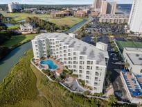 Aerial view of a condo building with pool, hot tub, and tennis courts at 9400 Shore Dr. # 309, Myrtle Beach, SC 29572