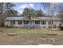 Charming ranch home with a metal roof, palm tree, and covered front porch at 1031 Madge Ct., Conway, SC 29526