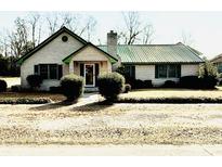 Charming brick home with a green metal roof, well-maintained landscaping, and a welcoming entrance at 11 S Beech Ave., Andrews, SC 29510