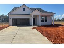 Charming single-story home with an attached garage and a concrete driveway at 148 Joyce Dr, Longs, SC 29568