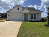 Charming single-story home featuring a tidy front yard and a light blue front door at 148 Joyce Dr, Longs, SC 29568