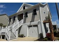 Charming coastal home with an elevated stairway and single-car garage at 172 Enclave Pl., Pawleys Island, SC 29585