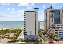 Lovely exterior view of a white high-rise condo building with a pool, beach and ocean views at 2001 S Ocean Blvd. # 1405, Myrtle Beach, SC 29577