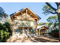 Striking two-story new construction home boasting unique wood beam design and large windows for an abundance of natural light at 204 81St Ave. N, Myrtle Beach, SC 29572