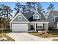 Charming one-story home featuring a two-car garage and a welcoming front porch at 2449 Campton Loop, Conway, SC 29527