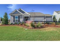 Charming single-story home featuring a two-car garage, well-manicured lawn, and professionally landscaped front yard at 2501 Brescia St., Myrtle Beach, SC 29579