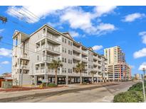 Beautiful exterior view of the condo building showcasing the various balconies and its proximity to the beach at 3401 N Ocean Blvd. # 109, North Myrtle Beach, SC 29582