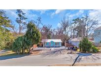 Charming cottage-style home featuring a white picket fence, blue door and shutters, and well-maintained landscaping at 3407 Poinsett St., North Myrtle Beach, SC 29582