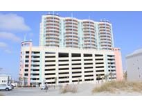 High-rise resort building featuring covered parking and multiple levels of residential balconies at 3601 N Ocean Blvd. # 1140, North Myrtle Beach, SC 29582