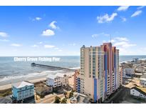 A view of the building and ocean from the exterior, with a fishing pier in the distance at 3601 N Ocean Blvd. # 1840, North Myrtle Beach, SC 29582