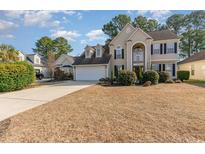 Charming two-story home with manicured lawn, inviting facade, and attached two-car garage at 364 Blackberry Ln., Myrtle Beach, SC 29579