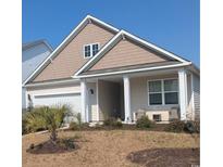 Charming single-story home featuring manicured lawn and classic architectural details at 498 Mcalister Dr., Little River, SC 29566