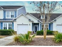 Charming home exterior features blue shutters, a one-car garage and well-maintained landscaping at 6244 Catalina Dr. # 4603, North Myrtle Beach, SC 29582