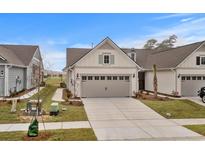 Charming two-story home with neutral siding, gray garage, and well-manicured landscaping at 6614 Torino Lane, Myrtle Beach, SC 29572