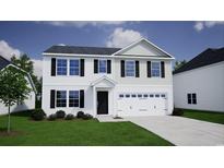 Charming two-story home featuring black shutters, a two-car garage, and a well-maintained lawn at 684 Mccorkle Place, Conway, SC 29526