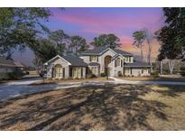 Stunning brick home with mature trees and a circular driveway at 78 Oakmont Dr., Pawleys Island, SC 29585